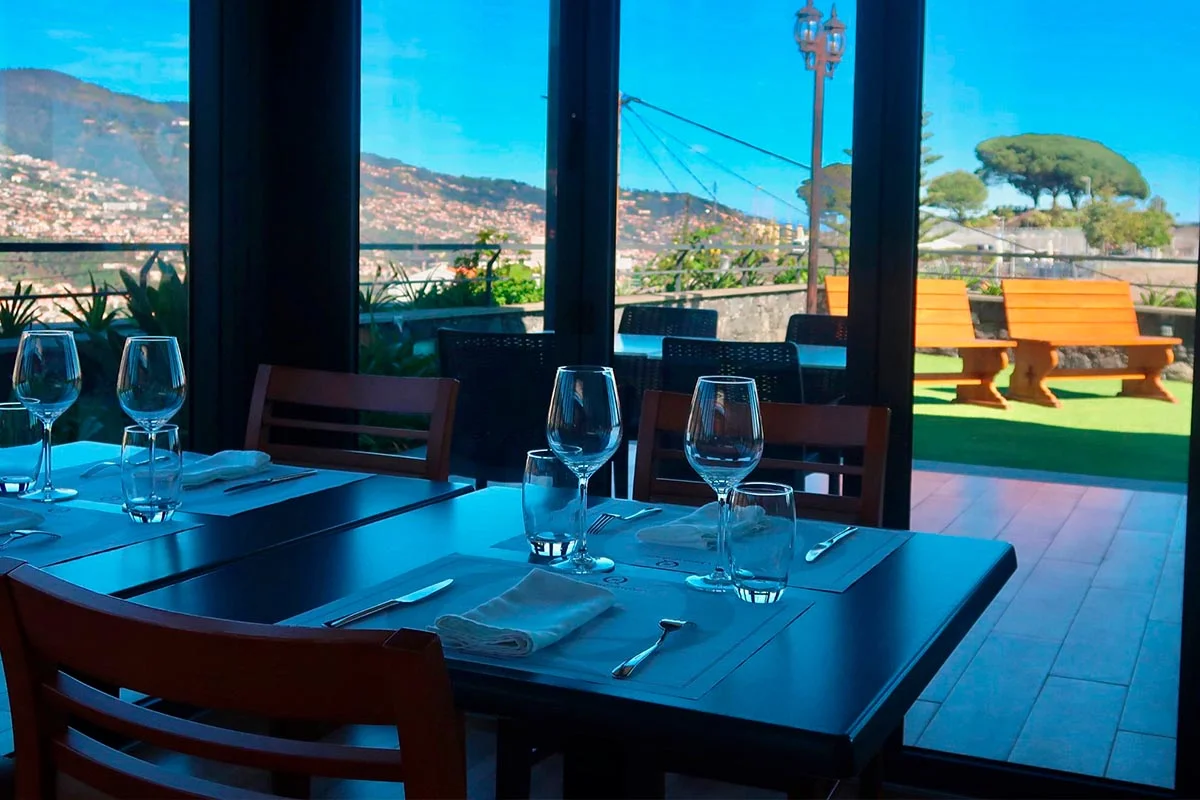 Table set with wine and food, overlooking Funchal